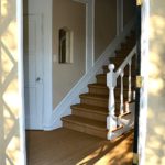 As the front door swings open you see the entry hall and stairs leading upstairs. Notice the nice mirror in the niche.