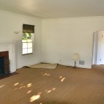 Turning around you see the entrance to the living room and the carpet being removed.