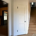 Back in the entry hall, the den is to the left, the stairs straight ahead and the dining room to the right.