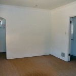 The spare bedroom with its dental molding and arched closet doorway.