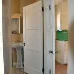 Standing in the hall and looking left you see a bathroom and the kitchen to the right.