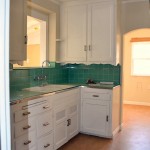 Walking in to the galley kitchen, the sink is to the left and ...