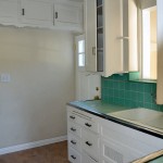 and to the right at the sink and back door. Notice the scroll work on the bottom of the cabinets.
