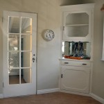 Looking to the left you see a door leading into the recreation room and one of the two built-in china cabinets.