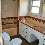 The hall bathroom has it's original tile, a tub and shower with a nice niche.